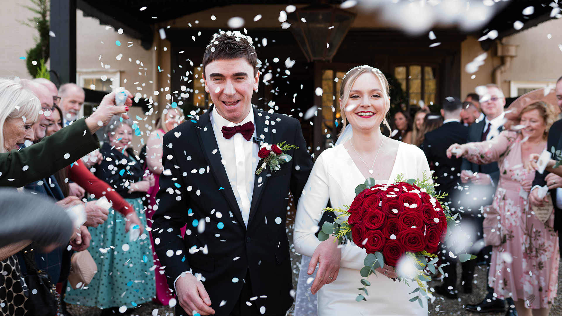 Bride and groom walking hand in hand during a sparkler farewell at Prested Hall Essex