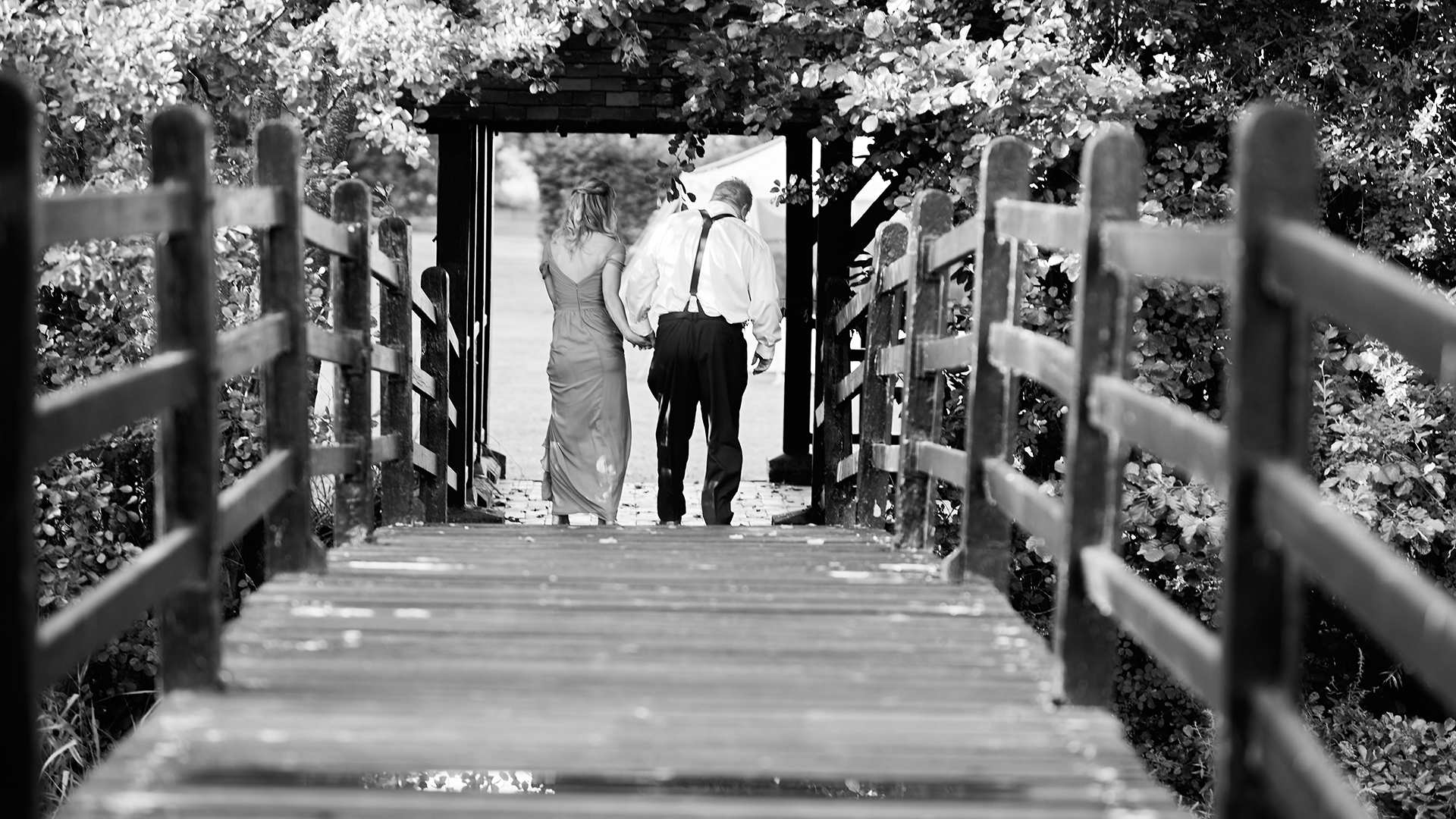 Bride framed by vintage doors of Prested Hall during wedding photography in Essex
