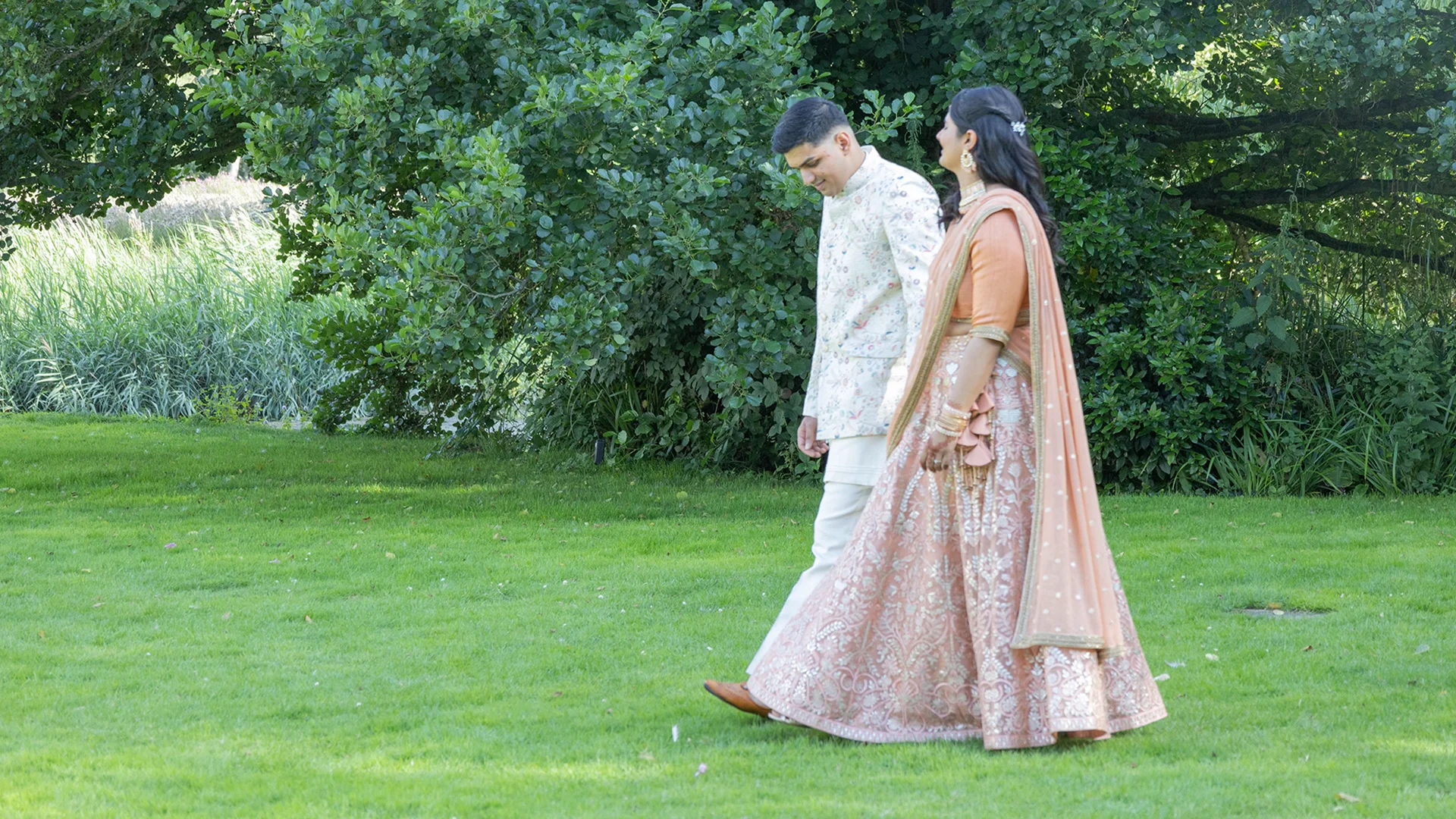 A couple enjoying a serene pre-wedding shoot by the misty moat, showcasing the beauty of a Morning Wedding Venue Essex.