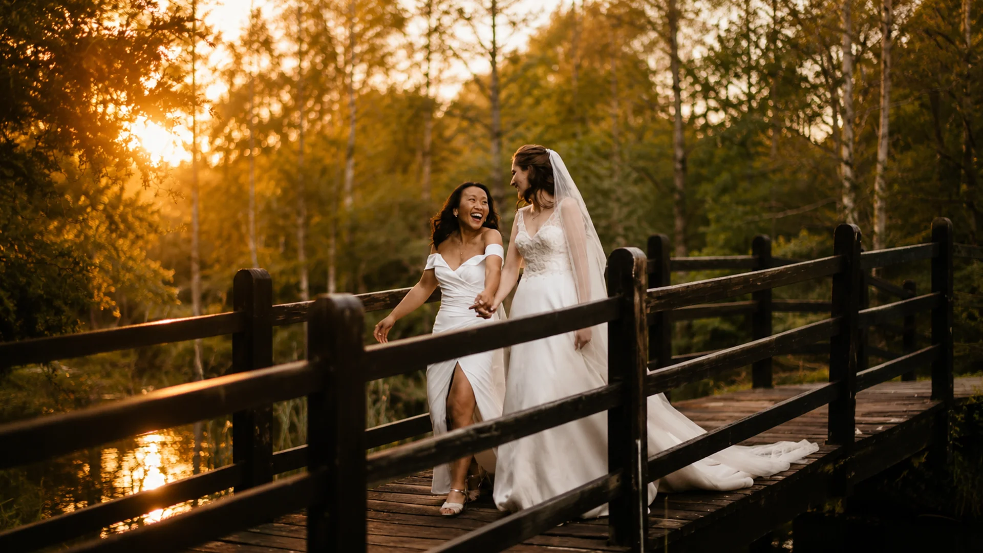 A breathtaking aerial drone shot of a couple standing on a 15th-century bridge, capturing the perfect cinematic wedding film Essex at Prested Hall.