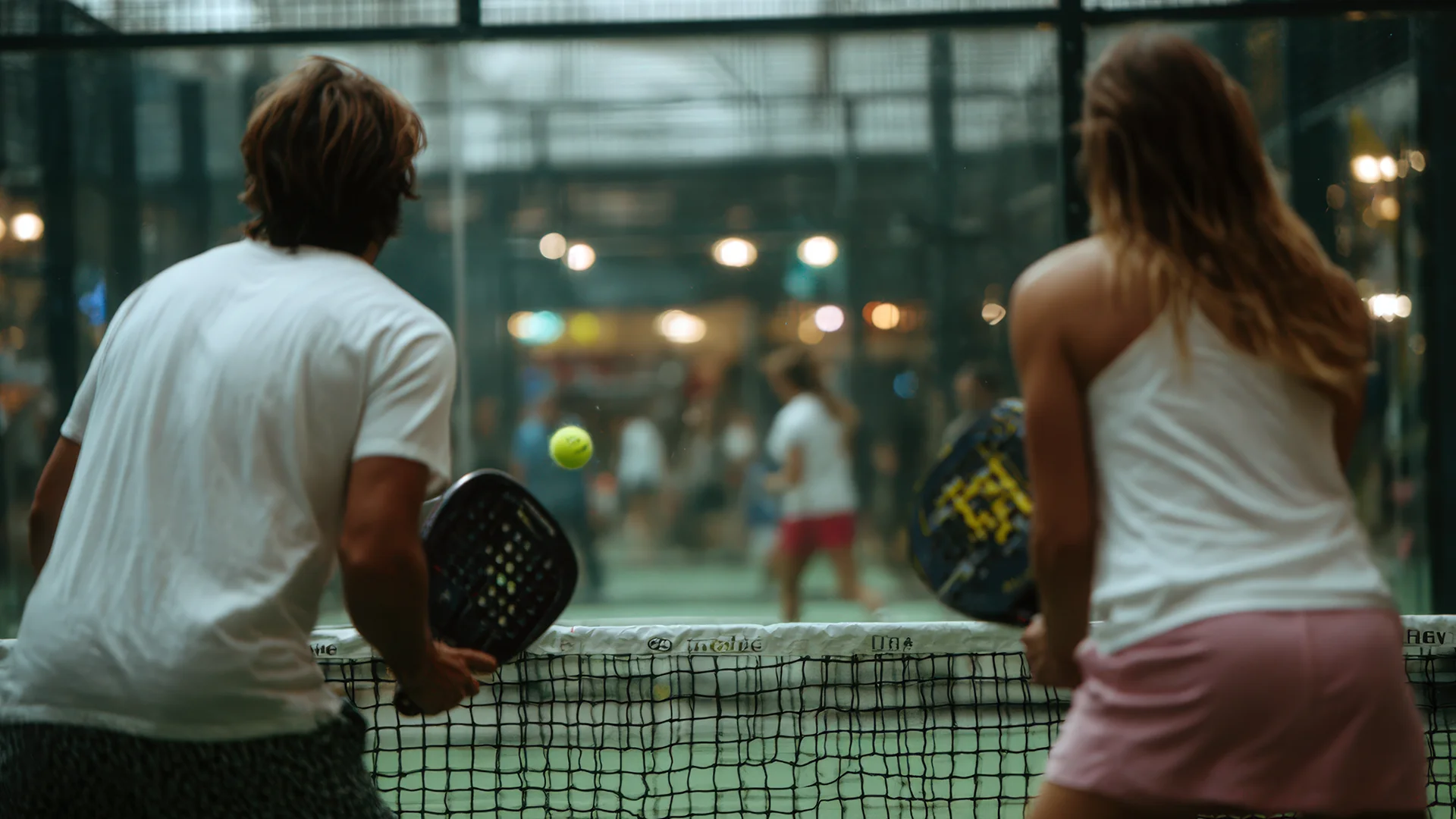 A energetic wedding party enjoying an interactive pre-wedding Padel match at a premier venue offering Team building wedding activities Essex.